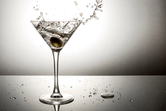 Olive splashing on martini