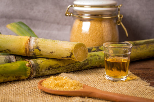 Extracting sugar cane juice with old traditional machine