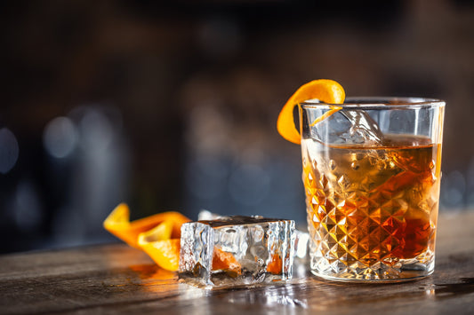 Old Fashioned with orange peel and ice cubes